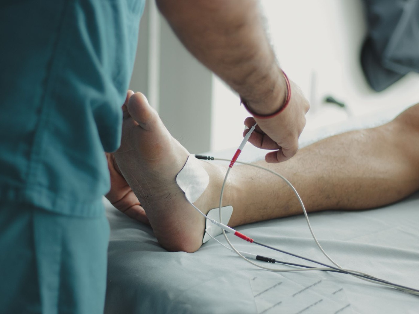 Clinician examining a patient's foot after an injury